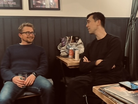 Men Talk Music members chatting with records on the table