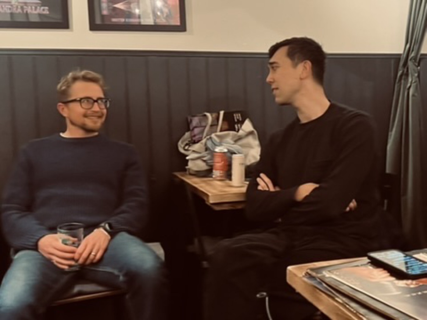 Two Men Talk Music members chatting with records on the table